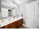 Bathroom with double sink vanity, a large mirror, and modern lighting fixtures at 149 Manor Ln, Woodstock, GA 30188
