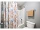 Bathroom with a shower featuring a shower curtain and a white toilet at 149 Manor Ln, Woodstock, GA 30188