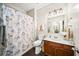 Bathroom featuring a shower/tub combo and a vanity with a single sink and floral shower curtain at 149 Manor Ln, Woodstock, GA 30188