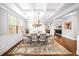 Charming dining room featuring coffered ceilings, wainscoting, hardwood floors and a stylish chandelier at 149 Manor Ln, Woodstock, GA 30188