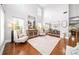 Elegant living room with soaring ceilings, hardwood floors, and abundant natural light at 149 Manor Ln, Woodstock, GA 30188