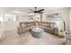 Spacious living room with a comfortable sectional couch, and a cozy ottoman at 149 Manor Ln, Woodstock, GA 30188
