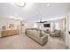 Large open living area with neutral carpet, ample seating, and a media cabinet at 149 Manor Ln, Woodstock, GA 30188