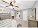 Comfortable main bedroom with ceiling fan, dresser, and doorways to bath and hall at 149 Manor Ln, Woodstock, GA 30188
