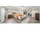 Luxurious primary bedroom features a tray ceiling, wood floors, and a sitting area with a fireplace at 149 Manor Ln, Woodstock, GA 30188