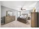 Well-lit main bedroom with a ceiling fan, large windows, and neutral decor at 149 Manor Ln, Woodstock, GA 30188