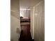The bedroom is visible from the hallway, showcasing hardwood floors and calming neutral tones at 200 Renaissance Ne Pkwy # 305, Atlanta, GA 30308