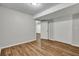 Clean finished basement with wood-look floors, neutral paint, and white closet doors at 2184 Cherokee Valley Cir, Lithonia, GA 30058