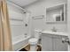 Bathroom features a shower-tub, toilet, gray vanity, and wood-look flooring at 2184 Cherokee Valley Cir, Lithonia, GA 30058