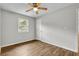 A bright bedroom features wood-look flooring and a ceiling fan at 2184 Cherokee Valley Cir, Lithonia, GA 30058
