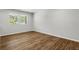 Bedroom with wood floors, base molding and two windows that allow natural light at 2184 Cherokee Valley Cir, Lithonia, GA 30058