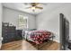 Bedroom with hardwood floors, ceiling fan, and natural light from the window at 2184 Cherokee Valley Cir, Lithonia, GA 30058