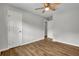 Bedroom with wood-look flooring, ceiling fan, and white doors at 2184 Cherokee Valley Cir, Lithonia, GA 30058