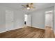 Bedroom with wood-look floors, a ceiling fan and 2 white doors at 2184 Cherokee Valley Cir, Lithonia, GA 30058