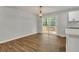 Bright dining area features a modern light fixture, hardwood floors, and access to the back deck at 2184 Cherokee Valley Cir, Lithonia, GA 30058