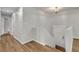 Hallway with wood floors, white trim, neutral paint, leading to a staircase and doorway at 2184 Cherokee Valley Cir, Lithonia, GA 30058