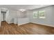 Hallway with wood floors, neutral paint and white trim, leading to several doorways at 2184 Cherokee Valley Cir, Lithonia, GA 30058