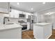 Modern kitchen featuring stainless steel appliances, quartz countertops, and a kitchen island at 2184 Cherokee Valley Cir, Lithonia, GA 30058
