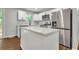 Modern kitchen with a stainless steel refrigerator, white cabinets, quartz countertops, and large kitchen island at 2184 Cherokee Valley Cir, Lithonia, GA 30058