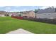 Large backyard with green grass and tall wooden privacy fence at 3650 River Rock Rd, Lithonia, GA 30038