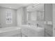 Modern bathroom featuring a double sink vanity and a soaking tub with tile surround at 3650 River Rock Rd, Lithonia, GA 30038
