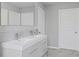 Modern bathroom featuring a double sink vanity and a tile backsplash at 3650 River Rock Rd, Lithonia, GA 30038