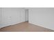 Bright bedroom featuring wood-look flooring and white paneled doors at 3650 River Rock Rd, Lithonia, GA 30038
