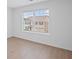 Bedroom with wood-look flooring; backyard view through window with closed blinds at 3650 River Rock Rd, Lithonia, GA 30038