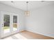Dining area with backyard access and modern ceiling light at 3650 River Rock Rd, Lithonia, GA 30038