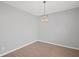 Clean, bright dining area with modern light fixture and light-colored wood flooring at 3650 River Rock Rd, Lithonia, GA 30038