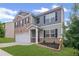 Beautiful two-story house with a brick and siding exterior, featuring a well-kept lawn and attractive landscaping at 3650 River Rock Rd, Lithonia, GA 30038