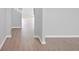Bright hallway featuring modern light-colored wood flooring with a view of stairs and an entry at 3650 River Rock Rd, Lithonia, GA 30038