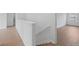 Second story hallway with wood-look floors, white trim and doorways at 3650 River Rock Rd, Lithonia, GA 30038