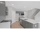 Modern kitchen features an island with quartz countertop and stainless steel appliances, and nearby stairwell at 3650 River Rock Rd, Lithonia, GA 30038