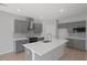 Modern kitchen features an island with quartz countertop and stainless steel appliances at 3650 River Rock Rd, Lithonia, GA 30038