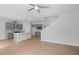 Open layout with modern kitchen, light wood flooring, and staircase at 3650 River Rock Rd, Lithonia, GA 30038