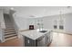 Living room with gas fireplace adjacent to modern kitchen with island, and nearby exit to the backyard at 3650 River Rock Rd, Lithonia, GA 30038