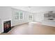 Open-concept living space with a fireplace, access to the backyard, and a modern kitchen at 3650 River Rock Rd, Lithonia, GA 30038