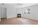 Bright living room featuring a fireplace, light wood flooring, and natural light from a window at 3650 River Rock Rd, Lithonia, GA 30038
