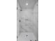 Luxurious walk-in shower with marble tile surround and a glass enclosure at 3650 River Rock Rd, Lithonia, GA 30038