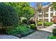 Lush courtyard landscaping surrounds the building exterior with mature trees and flowering bushes at 955 Juniper Ne St # 4332, Atlanta, GA 30309