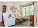 Bright living room featuring a comfortable gray sectional and large window with backyard views at 955 Juniper Ne St # 4332, Atlanta, GA 30309