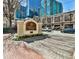 Welcoming Tuscany Condominiums signage with manicured flower beds and brick-paved entrance in a vibrant city setting at 955 Juniper Ne St # 4332, Atlanta, GA 30309