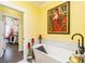 Bright bathroom showcasing a standalone tub and large framed artwork at 963 South On Main Dr, Woodstock, GA 30188