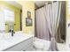Well-lit bathroom with a shower-tub combo and stylish gray accents at 963 South On Main Dr, Woodstock, GA 30188