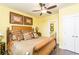 Comfortable bedroom with yellow walls, a ceiling fan, and a well-appointed en-suite bathroom at 963 South On Main Dr, Woodstock, GA 30188