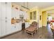 Dining room with wine storage, comfortable armchair, and yellow walls at 963 South On Main Dr, Woodstock, GA 30188