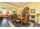 Yellow dining room with chandelier, antique cabinet, and seating for eight at 963 South On Main Dr, Woodstock, GA 30188