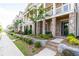 Close-up of the front of a brick townhome with a cozy porch, neat landscaping, and a well-maintained facade at 963 South On Main Dr, Woodstock, GA 30188