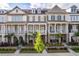 Attractive townhomes showcase brick and siding exteriors with well-maintained landscaping and inviting front porches at 963 South On Main Dr, Woodstock, GA 30188